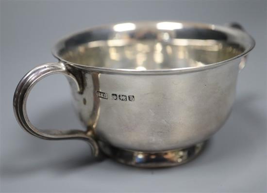 A 1930s silver cream jug, a silver sugar bowl and a silver caster, 9oz.